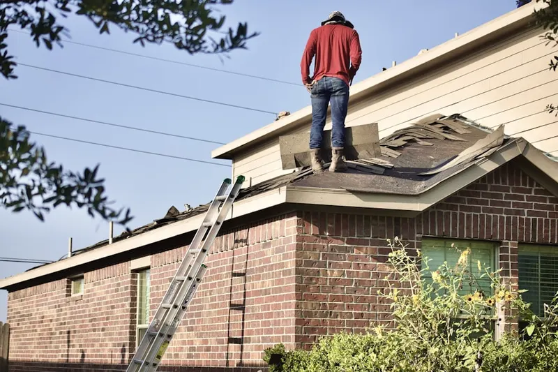 Professional roofer working on a residential roof in Waterview